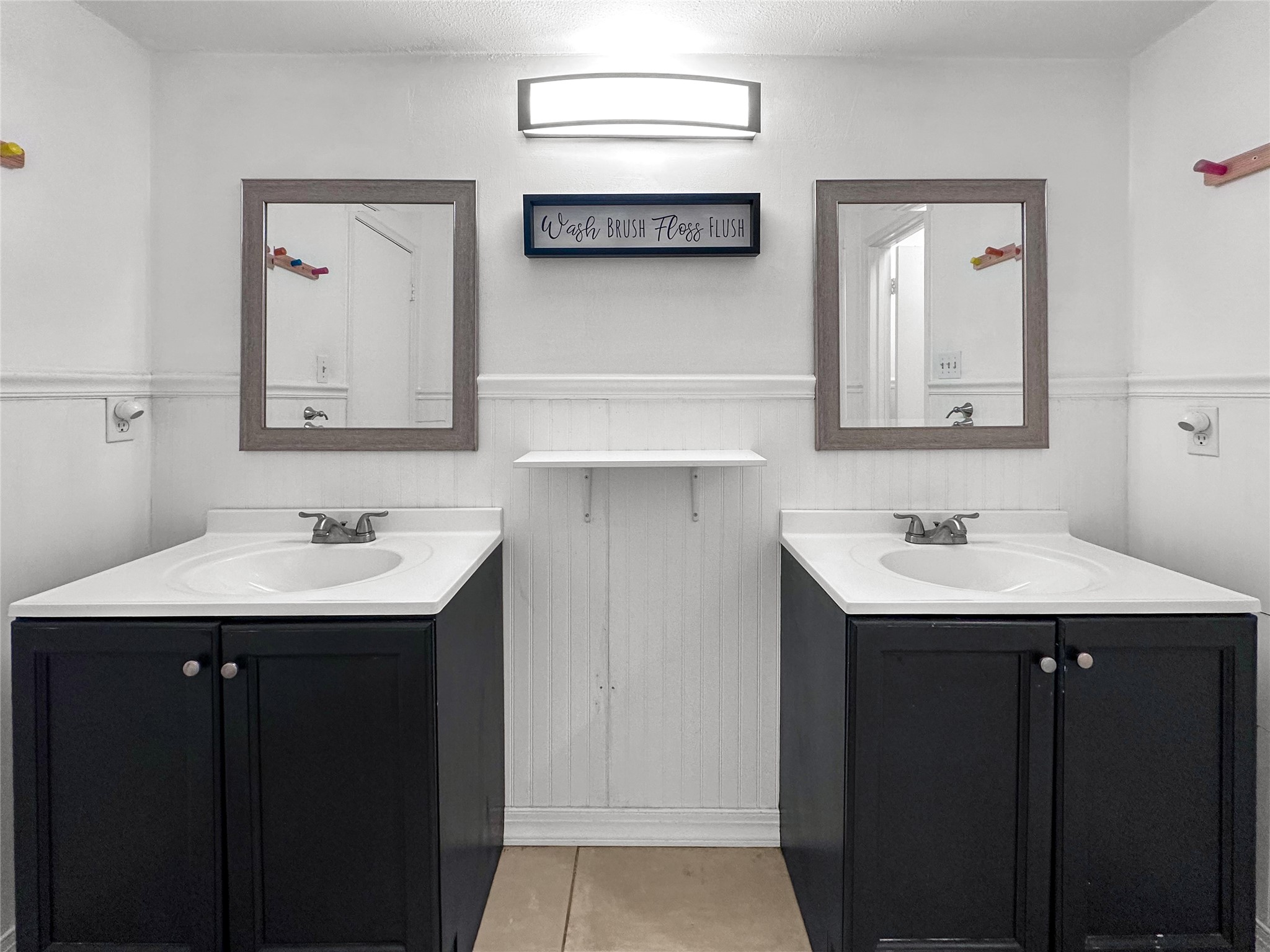 6511 Castle Pine Lane Spring, TX 77379 - Photo 30 of 49 Elegant dual-vanity featuring modern cabinetry, framed mirrors, updated lighting, and a clean, sophisticated design that creates a spa-inspired retreat feel.