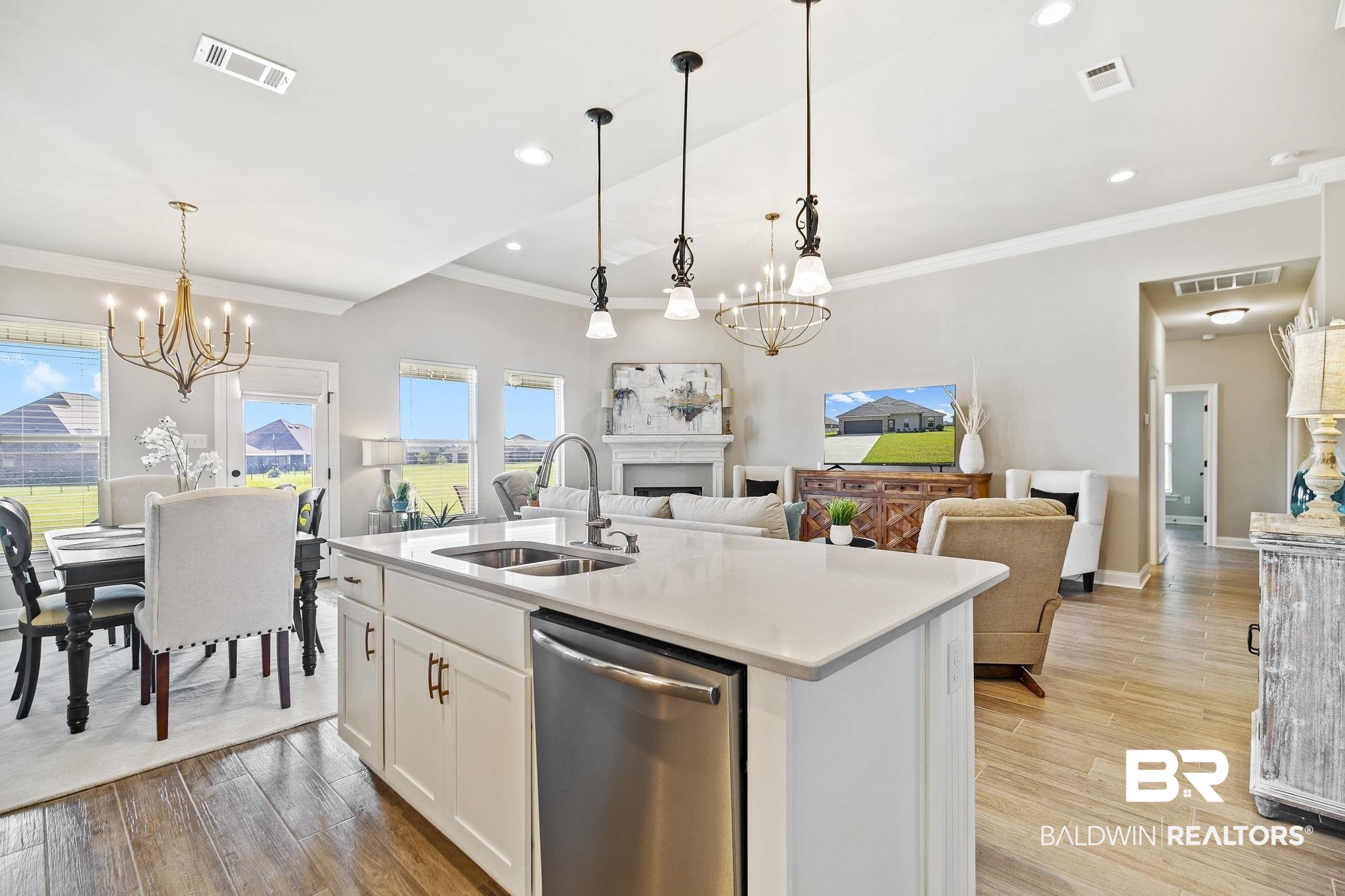 10140 Chipper Lane Foley, AL 36535 - Photo 19 of 72 Kitchen featuring sink, a kitchen island with sink, stainless steel dishwasher, and light wood-type flooring