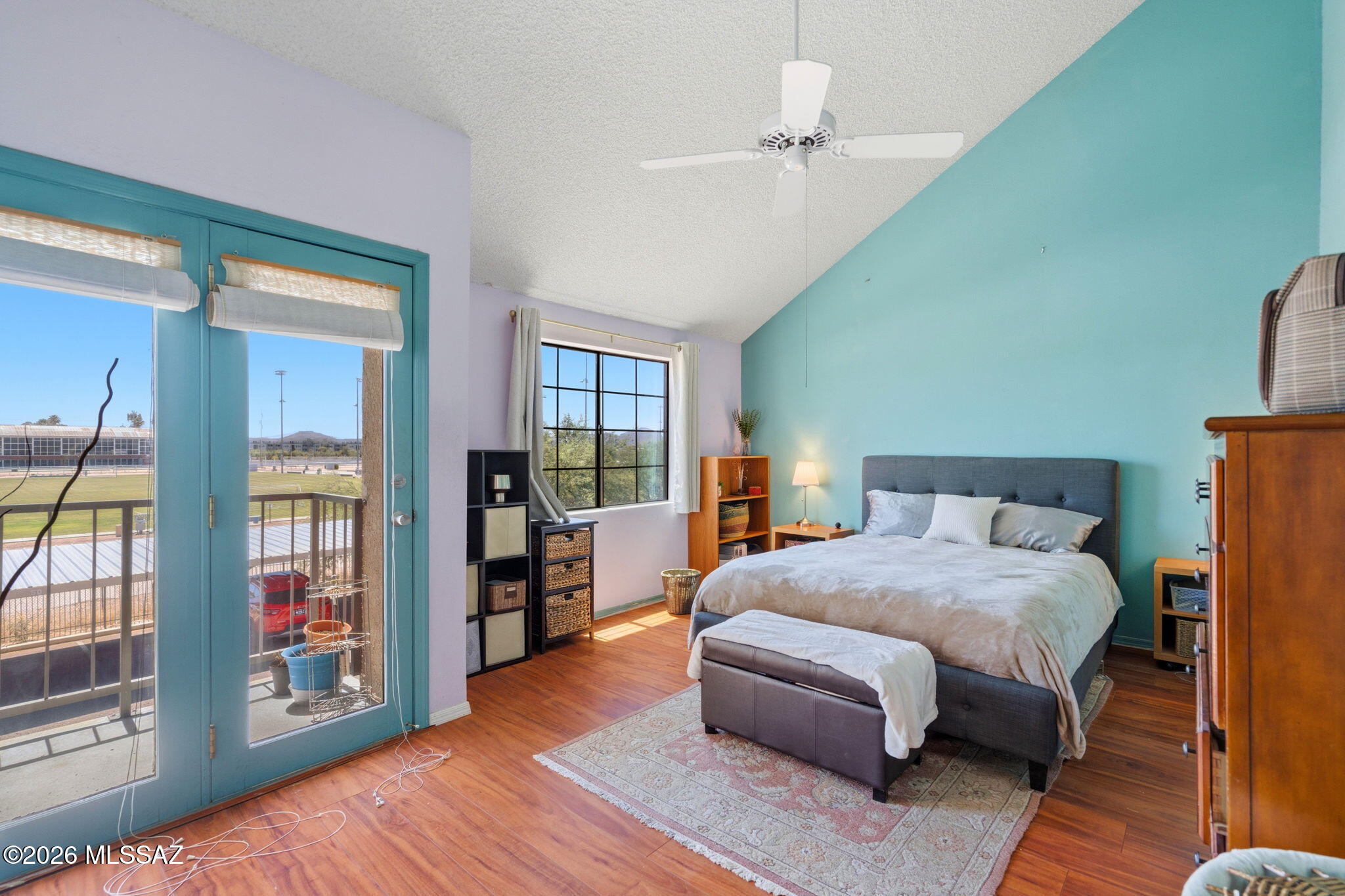 1200 East River Road, Unit G87 Tucson, AZ 85718 - Photo 14 of 30 a spacious bedroom with a large bed and a wooden floor