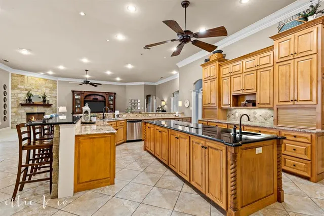 a kitchen with stainless steel appliances kitchen island granite countertop a sink and cabinets
