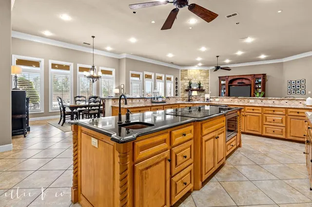 a kitchen with stainless steel appliances granite countertop a sink and a refrigerator