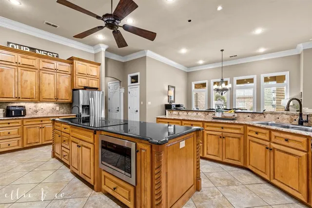 a kitchen with stainless steel appliances granite countertop a sink and cabinets