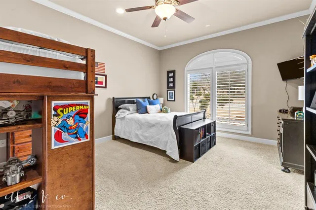 a bedroom with a bed dresser and window