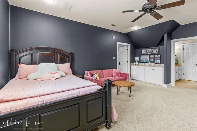 a bedroom with a bed and view of kitchen