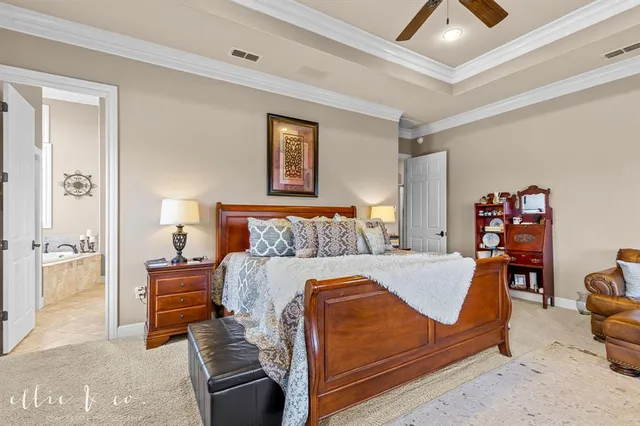 a spacious bathroom with a double vanity sink a mirror and a bathtub