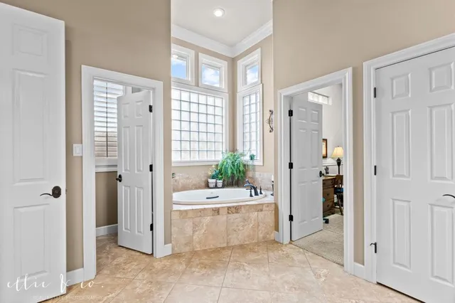 a spacious bathroom with a granite countertop sink and a mirror