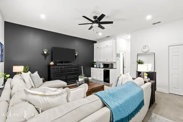 a bathroom with a granite countertop toilet sink and mirror