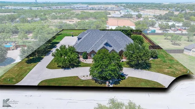 an aerial view of residential houses with outdoor space and swimming pool