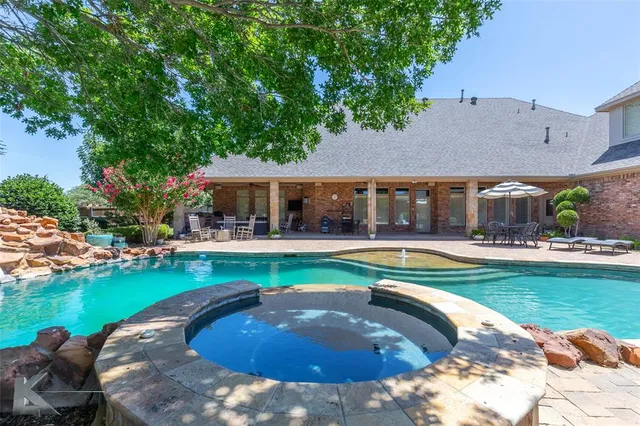 a view of a house with swimming pool and a yard
