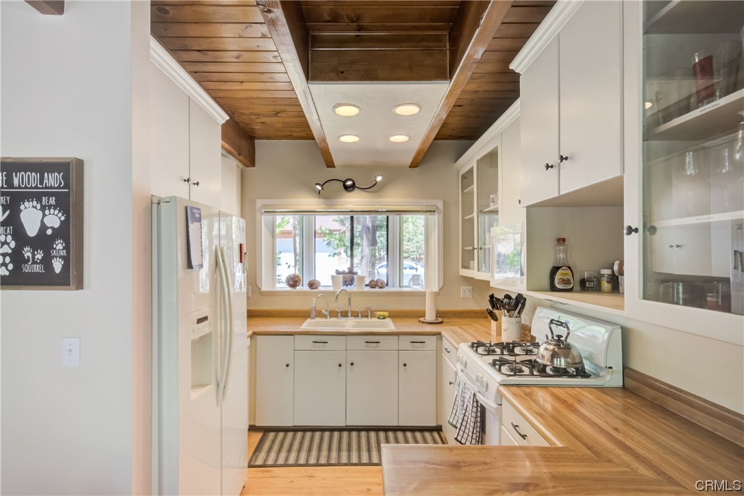 1017 Burnt Mill Road Lake Arrowhead, CA 92352 - Photo 12 of 32 a large white kitchen with a large window