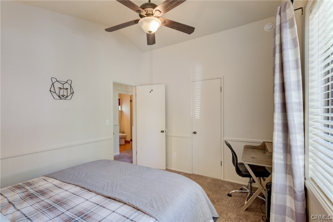 1017 Burnt Mill Road Lake Arrowhead, CA 92352 - Photo 17 of 32 a bedroom with a bed and a chandelier fan