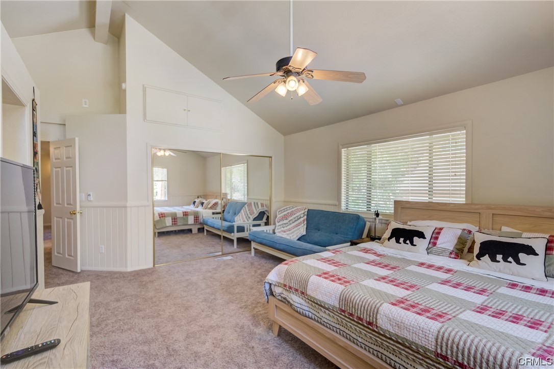 1017 Burnt Mill Road Lake Arrowhead, CA 92352 - Photo 22 of 32 a bedroom with a large bed and a chandelier