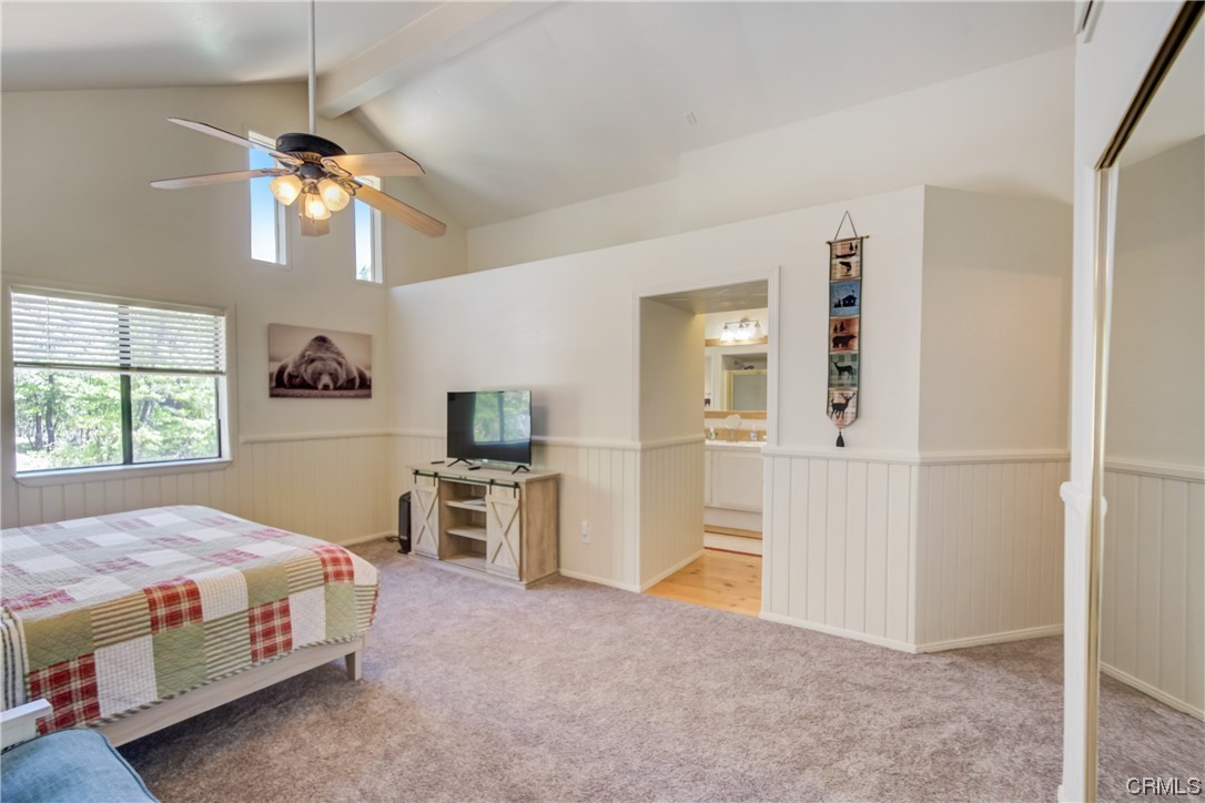 1017 Burnt Mill Road Lake Arrowhead, CA 92352 - Photo 24 of 32 a bedroom with a bed and a chandelier