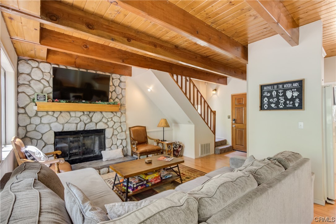 1017 Burnt Mill Road Lake Arrowhead, CA 92352 - Photo 7 of 32 a living room with furniture a flat screen tv and a fireplace