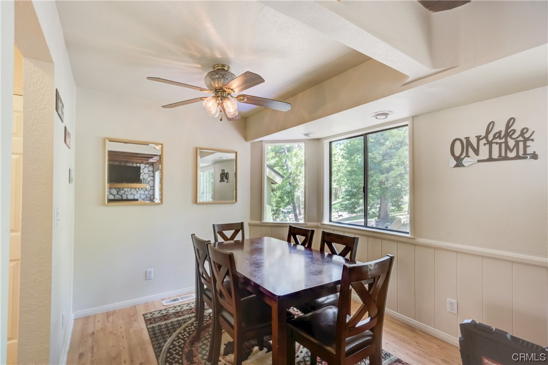 1017 Burnt Mill Road Lake Arrowhead, CA 92352 - Photo 8 of 32 a view of a dining room with furniture window and wooden floor