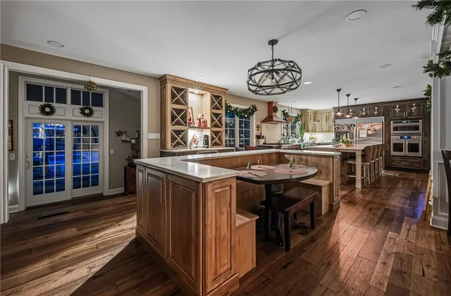 a kitchen with stainless steel appliances granite countertop a stove and a wooden floors