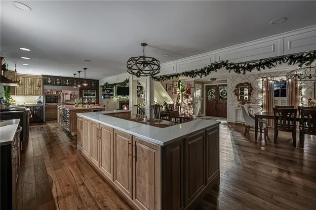 a kitchen with stainless steel appliances granite countertop a stove and a wooden floors