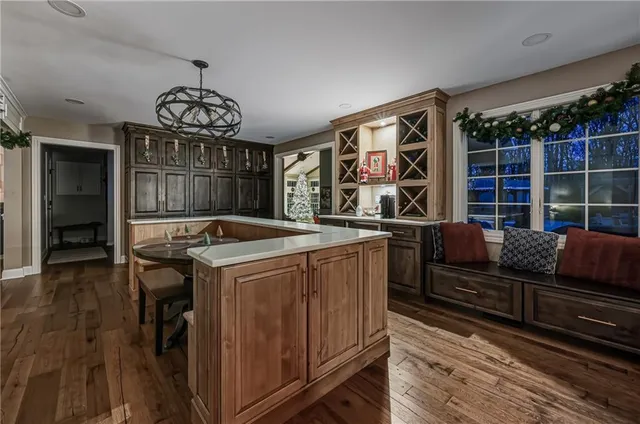 a view of a dining room with furniture wooden floor and chandelier