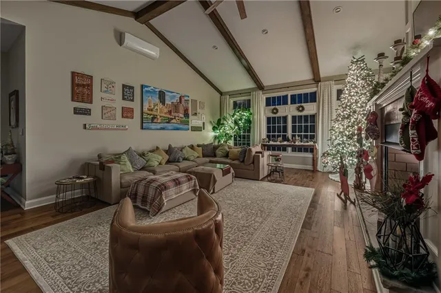 a living room with furniture and a floor to ceiling window
