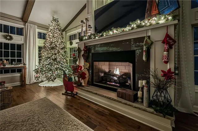 a living room with a fireplace a flat screen tv and a potted plant