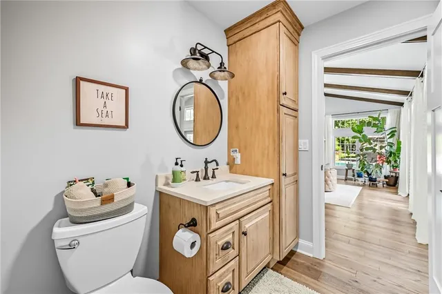 a bathroom with a sink a mirror and a toilet