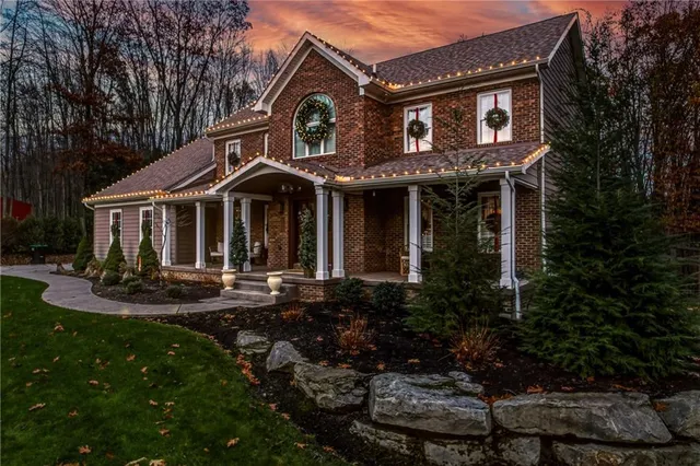 a front view of a house with garden