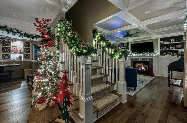 a room with lots of flowers and a fireplace