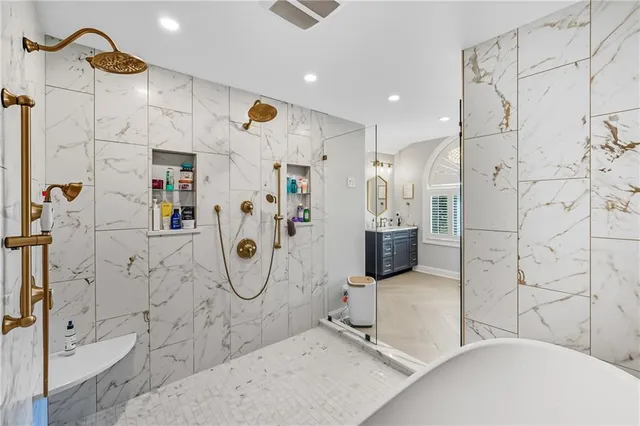 a bathroom with a tub sink and shower