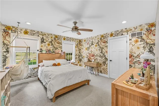 a bedroom with a bed couch and window