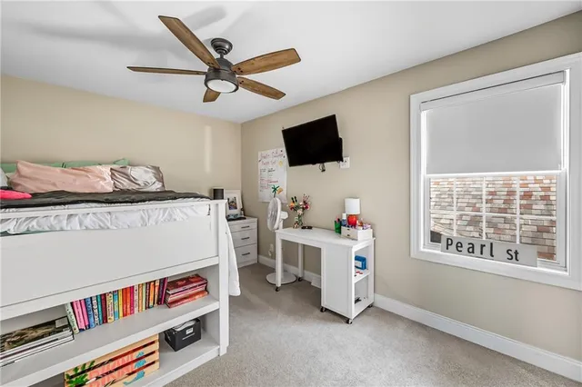 a room with furniture a flat screen tv and a window