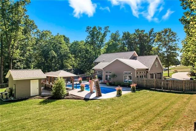 a swimming pool view with a seating space