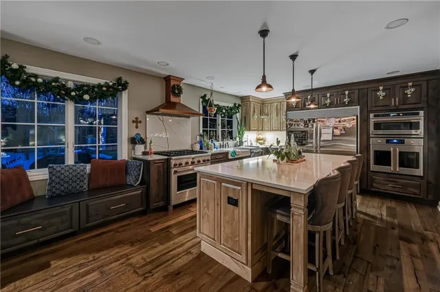 a kitchen with stainless steel appliances granite countertop a stove and a refrigerator