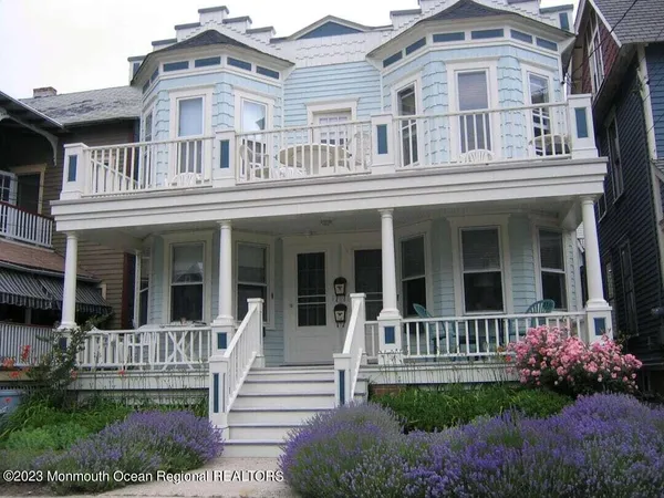 front view of a brick house with a yard