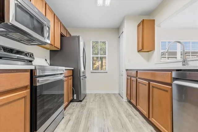 a kitchen with a refrigerator and a sink
