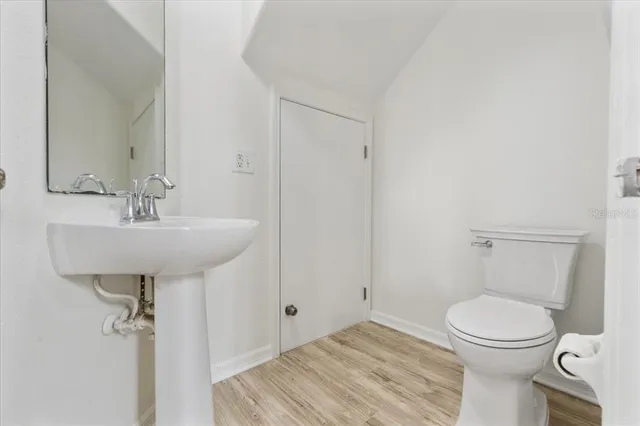 a bathroom with a sink toilet and a mirror