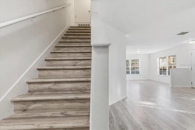 a view of an entryway with wooden floor