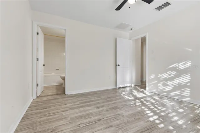 a view of a room with wooden floor and white walls