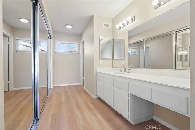 a spacious bathroom with a double vanity sink and a mirror