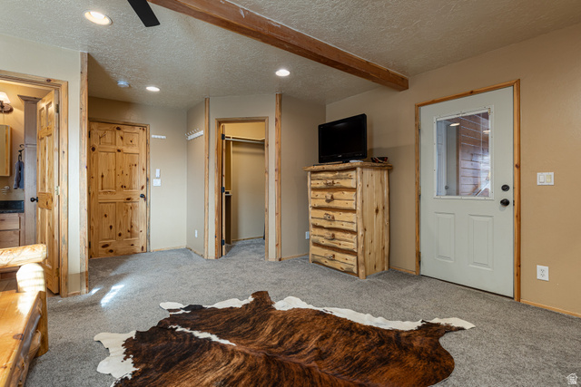 1505 West Elk Ridge Drive Alton, UT 84710 - Photo 13 of 53 Carpeted bedroom featuring a spacious closet, a textured ceiling, a ceiling fan, recessed lighting, and beam ceiling