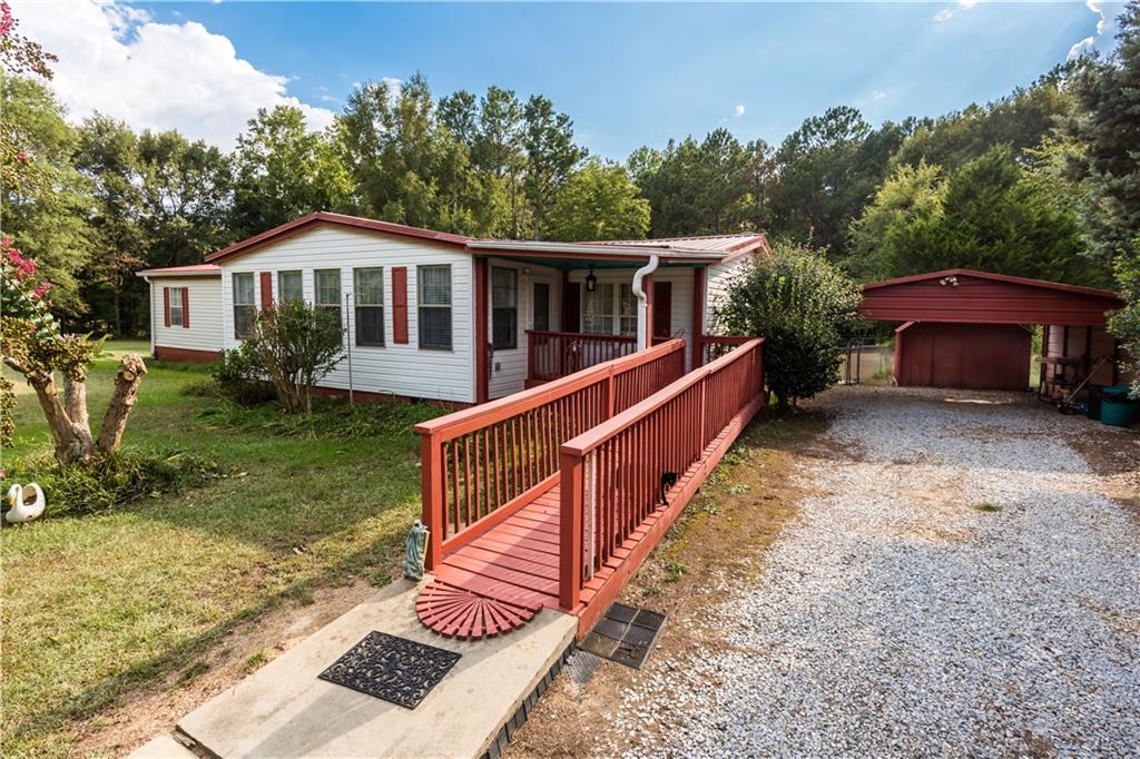 475 McCarty-Dodd Road Colbert, GA 30628 - Photo 1 of 1 a front view of a house with yard and green space