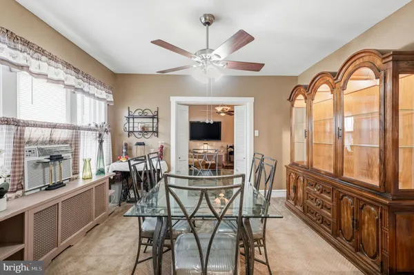 a dining room with furniture window and wooden floor
