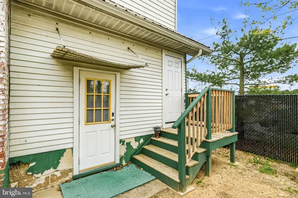 an empty room with closet and windows