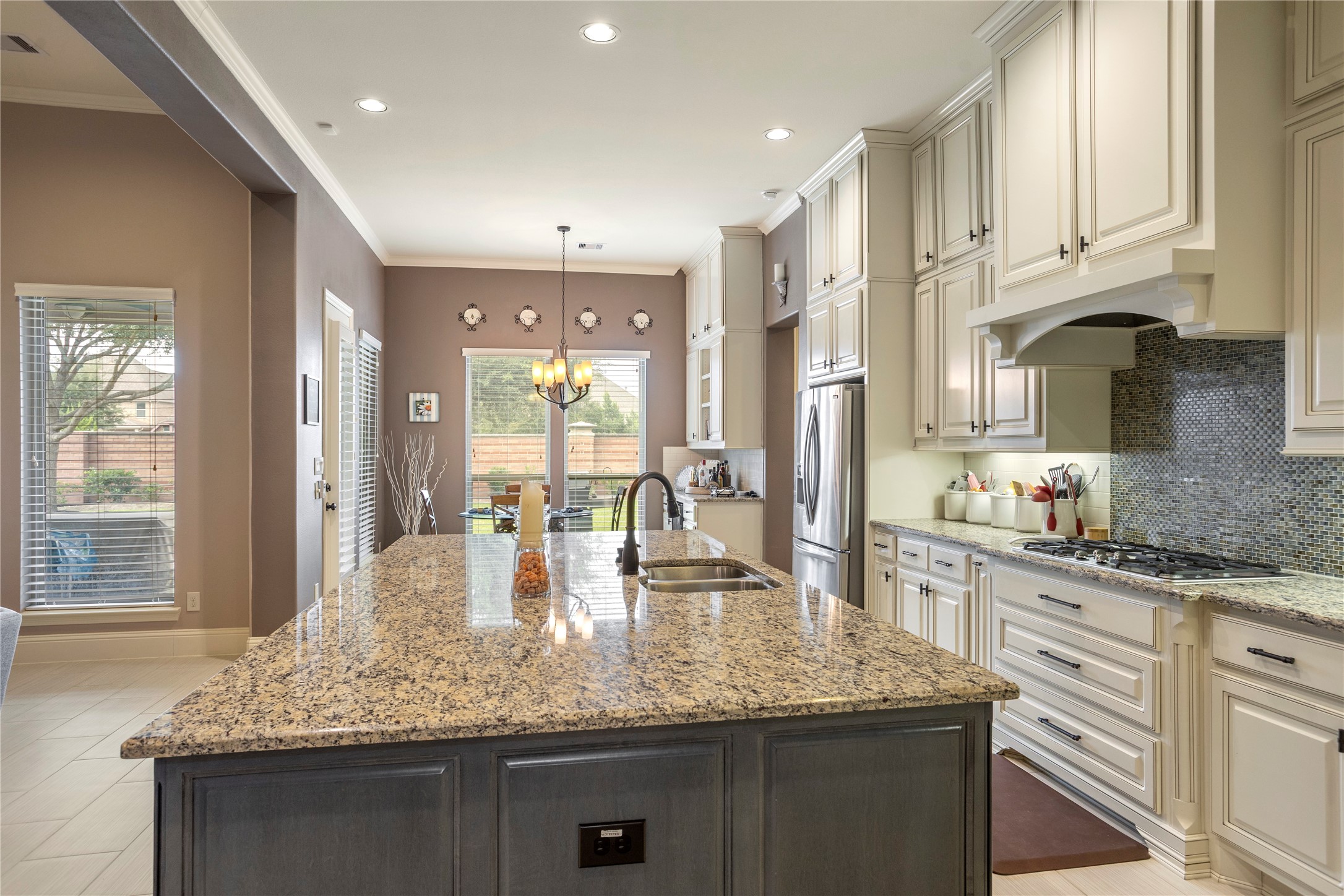 17610 Astrachan Road Richmond, TX 77407 - Photo 11 of 25 a kitchen with kitchen island granite countertop a large counter top space appliances and cabinets