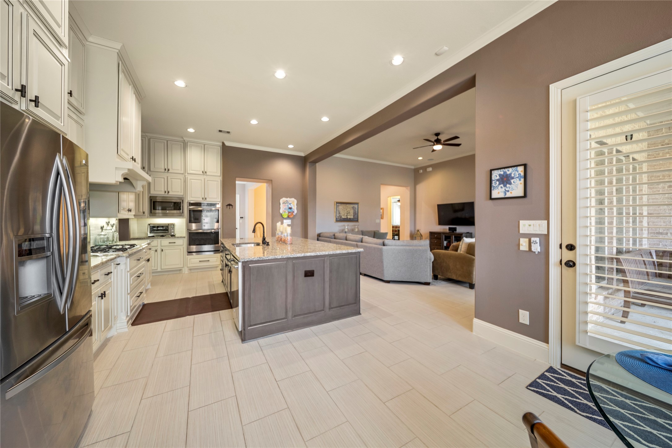 17610 Astrachan Road Richmond, TX 77407 - Photo 12 of 25 a large white kitchen with stainless steel appliances lots of counter space and windows