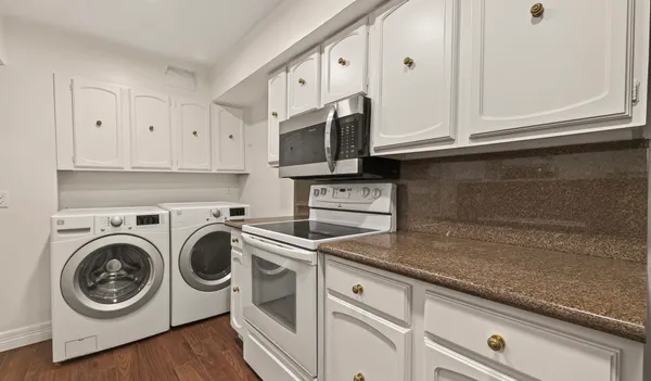 a kitchen with stainless steel appliances white cabinets and a sink
