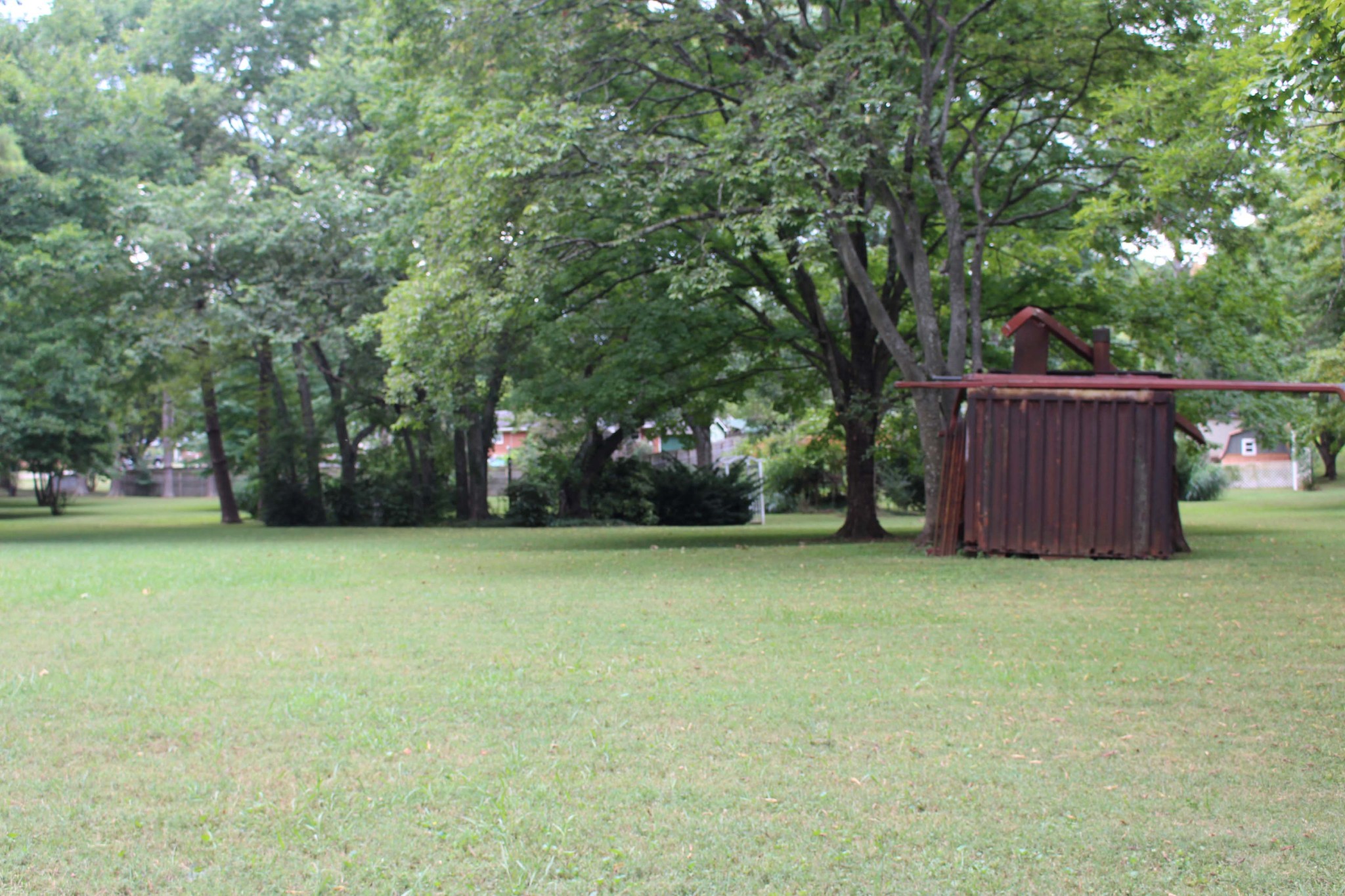1426 Avon Road Murfreesboro, TN 37129 - Photo 9 of 46 a view of a backyard with large trees and wooden fence
