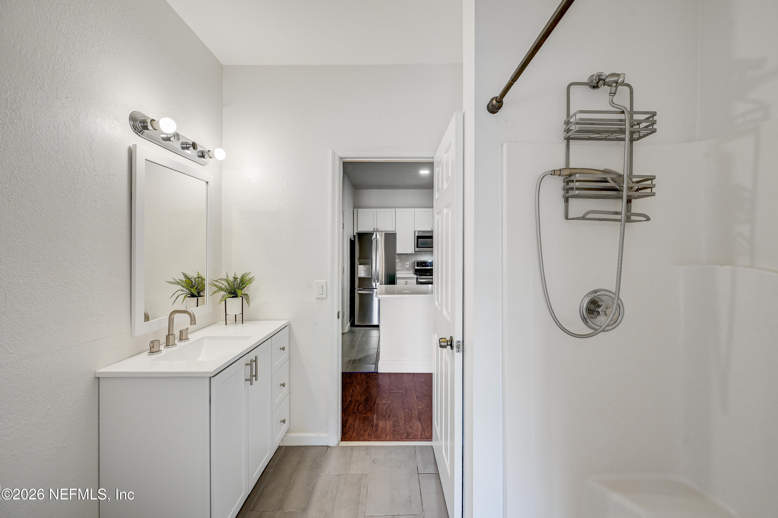 10961 Burnt Mill Road, Unit 824 Jacksonville, FL 32256 - Photo 14 of 35 a bathroom with a sink a mirror and shower