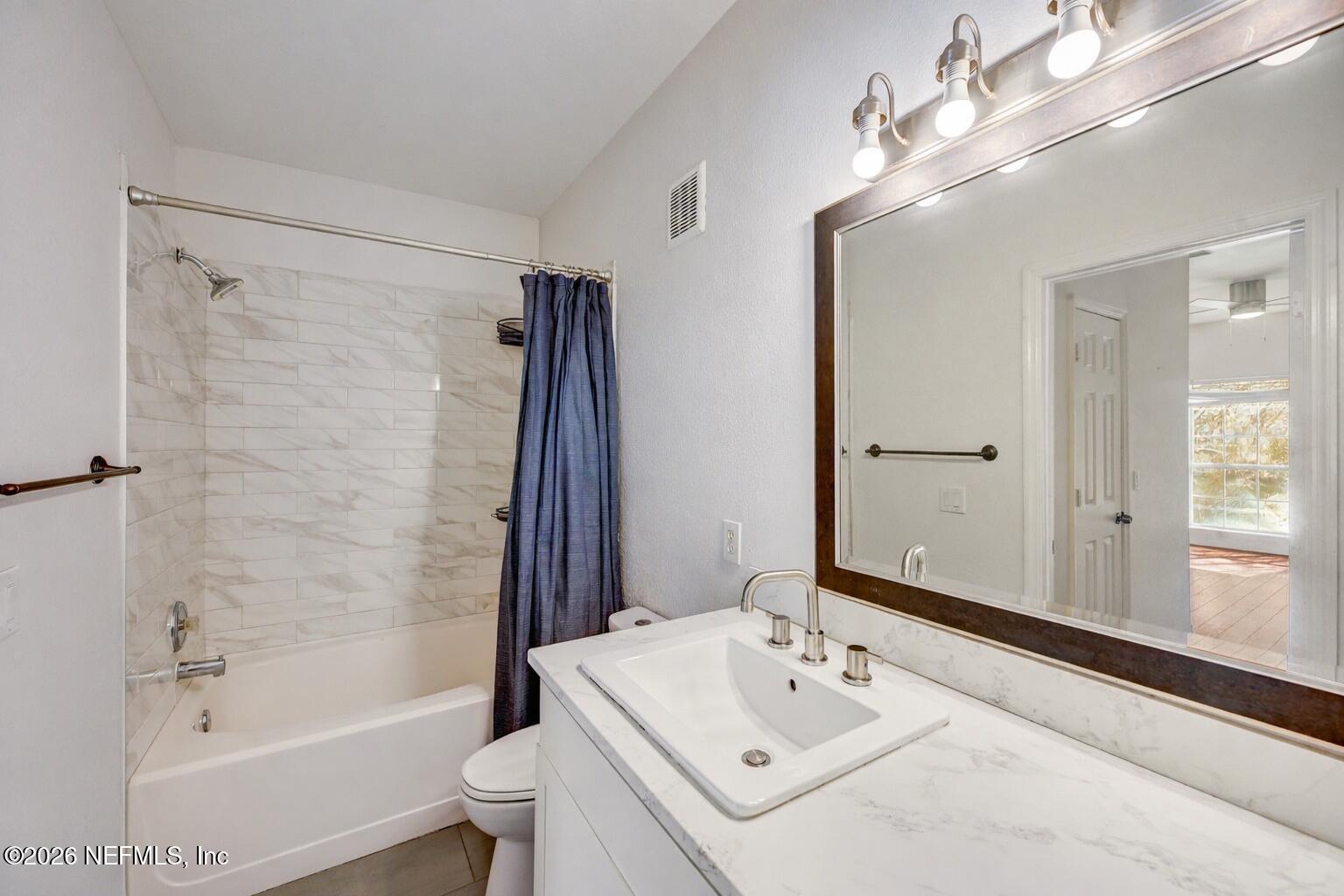 10961 Burnt Mill Road, Unit 824 Jacksonville, FL 32256 - Photo 17 of 35 a bathroom with a sink a toilet and shower