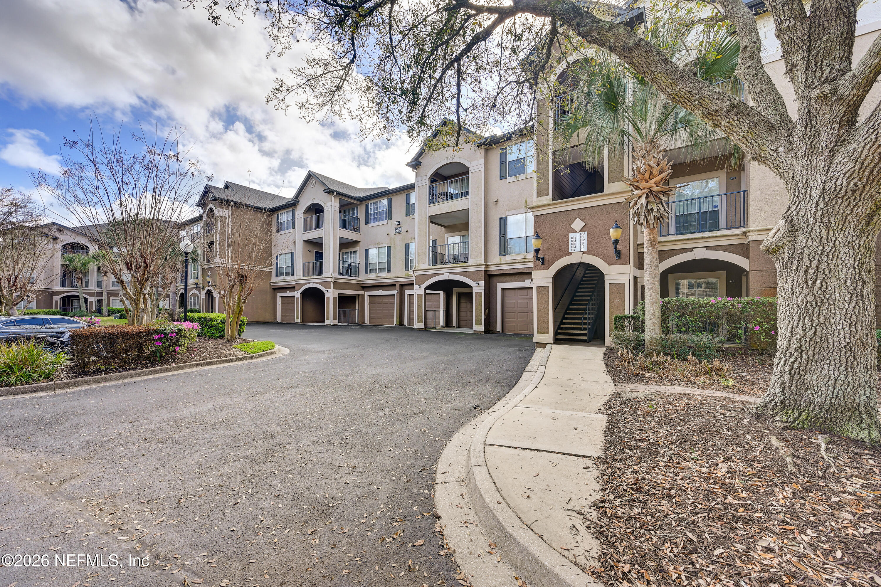 10961 Burnt Mill Road, Unit 824 Jacksonville, FL 32256 - Photo 2 of 35 a view of a large white building among the street