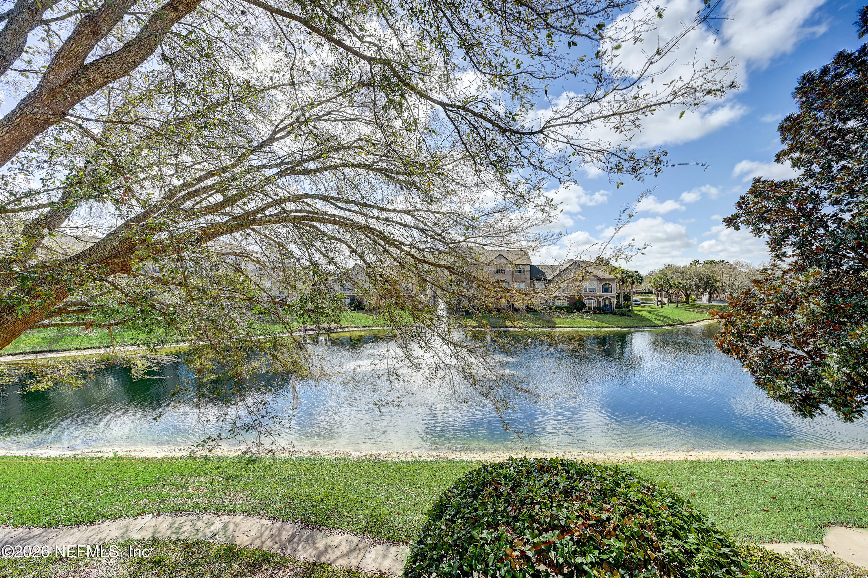 10961 Burnt Mill Road, Unit 824 Jacksonville, FL 32256 - Photo 21 of 35 a view of a lake from a yard